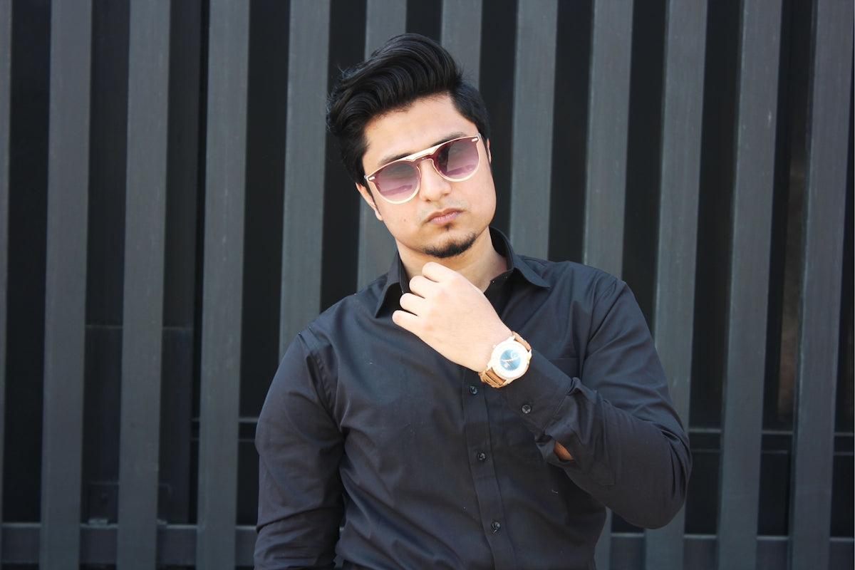 man wearing black dress shirt showing gold-colored watch